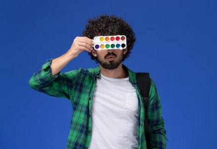 Man covering his eyes with watercolor palette