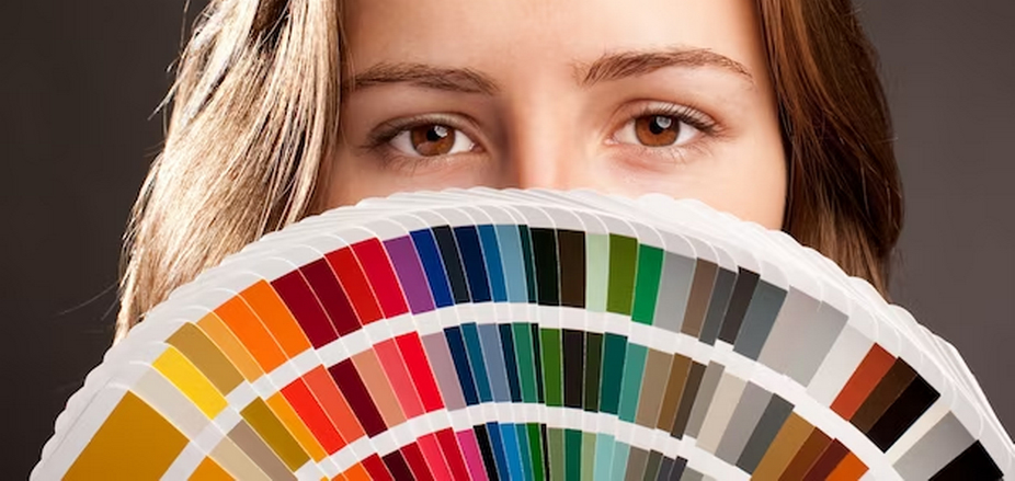 Woman partially concealing her face with a color palette